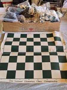 lot 82 image: 1990 National Elementary Chess Championship board with Approx. 9 sets of Chess Pieces (uncounted)