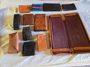 lot 122 image: Leather Wallets and Accessories including Ray-Ban Case, Embossed Wallets, and Leather Case for Ties Maybe