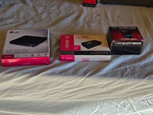 lot 164 image: LG Slim Portable DVD Writer GP50, T-Mobile LineLink, and Timex Sinclair 16K RAM Module