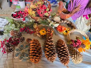 lot 255 image: Lot of Decorative Fall and Holiday Items including Large Pine Cones, Baskets, and Floral Arrangements