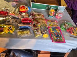 lot 278 image: Assorted Vintage Toy Collection Including McGruff Comic Books, Grinch Plush, and Snoopy Toy Set