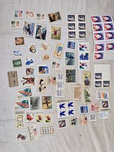lot 496 image: Lot of Vintage UNUSED USA Postage Stamps Including Christmas, Love, and Aviation Themes