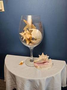 lot 65 image: Oversized Decorative Wine Glass Filled with Natural Seashells & Starfish