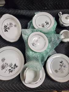 lot 42 image: Porcelain Dinnerware Set - Floral Rose Pattern on White with Black Rim and Gold Trim