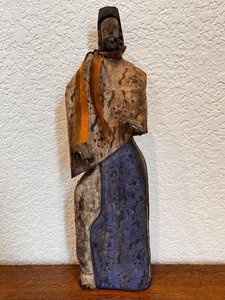 lot 94 image: Hand-Carved Folk Art Wood Figure with Blue Accents and Ribbon