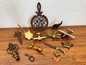 lot 95 image: Eclectic Vintage Collectibles Lot with Toy Planes, Trivet, and Decorative Items