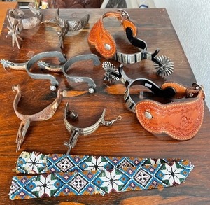 lot 151 image: Collection of Western Spurs with Tooled Leather and Beaded Strap