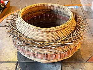 lot 238 image: Decorative Handwoven Wicker Basket with Twig Accent