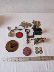 lot 23 image: Eclectic Vintage Collectibles Lot with Figurines, Brass Signs, and Tokens
