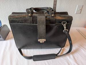 lot 26 image: Black Leather Briefcase with Shoulder Strap and Dual Compartments