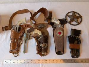 lot 172 image: Vintage Western Toy Cap Gun Holsters and Texas Star Badge Collection