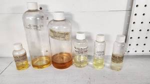 lot 74 image: Rustic Escentuals and Summers Earth Fragrance Oils Set including Lavender Latte, Barbershop 1920s, and Cardamom Cedar Oils - All Partials