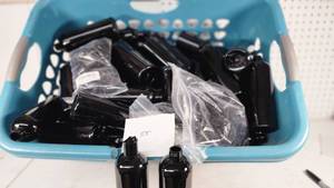 lot 107 image: Black Bullet Cosmo Round Bottles with Some Pump Dispensers - Bottles about 7 Tall - 38 Bottles, Dispensers Not Counted