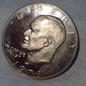 lot 81 image: 1973 Ike Proof BU Dollar and 1974 AU Toned