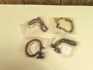 lot 94 image: Bracelets  - (green, purple, black, silver)