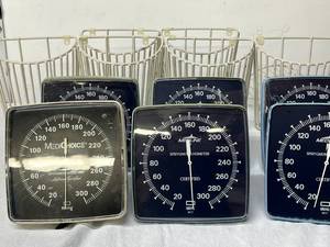 lot 99 image: Lot of Mixed Brand Wall Mount Blood Pressure Aneroid Sphygmomanometers with Wire Baskets (MediChoice, Medline) - Great Condition