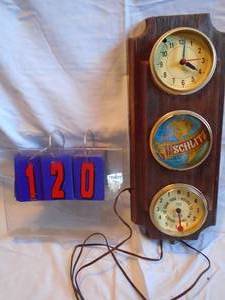 lot 120 image: Schlitz wall clock with tide gauge. Clock works. Approx 2 tall. As shown.