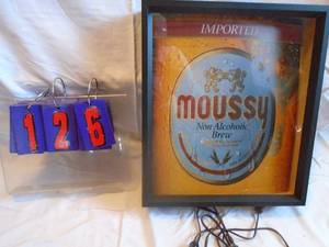 lot 126 image: New in box Moussy NA beer sign. Lighted. Needs to be reattached to frame. As shown.