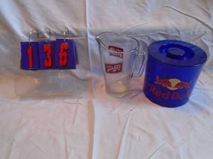 lot 136 image: Schlitz beer pitcher & Red Bull ice bucket. As shown.