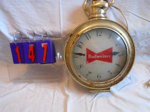 lot 147 image: Budweiser pocket watch rotating clock. Apparetnly early 1950s. Clock & spin work. As shown.