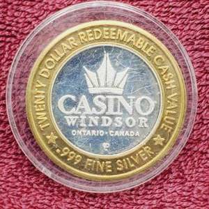 lot 109 image: Gaming Token in Airtite--Center is .60 toz. of .999 Silver