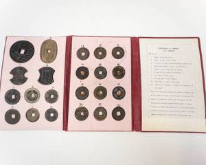 lot 138 image: Japanese coin collection book 2 of 3 22 different coins mounted in album