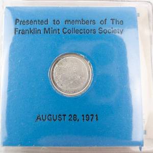 lot 141 image: Limited edition mini coin made from a melt of silver that traveled to the moon with Apollo 14