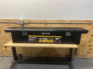 lot 7 image: Northern Tool  Equipment Slim Low-Profile Crossover Truck Toolbox, 69in. x 12in. x 13in., Aluminum, Gloss Black, Paddle Latches MSRP $399.99