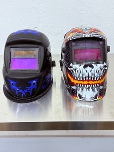 lot 15 image: Lot of 2 Auto-Darkening Welding Helmets Arccaptain Skull &amp Chicago Electric Blue Flames