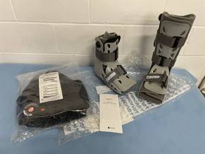 lot 83 image: Lot of 2 AirCast AirSelect Durable Foot Shell Walking Boots, Aspen Horizon 631 Back Brace and Knee Stabilization Brace