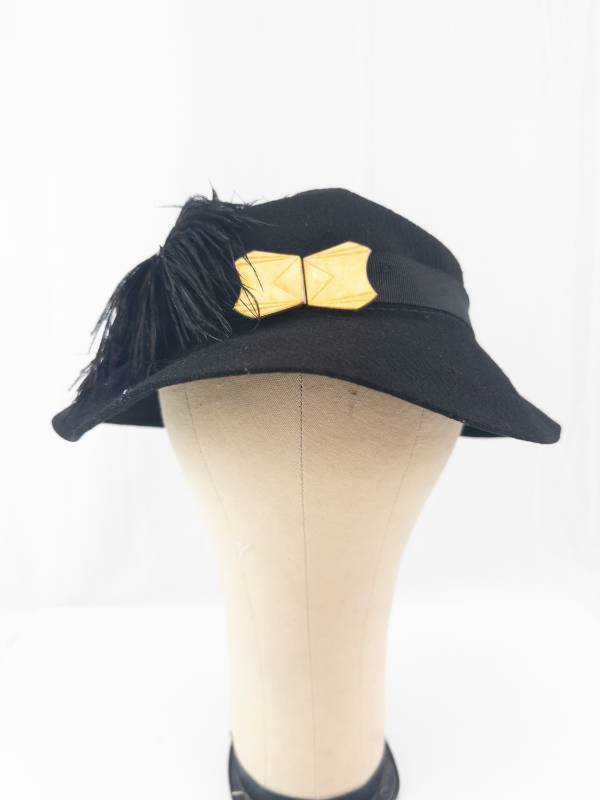 lot 132 image: Black Felt Cloche Hat with Feather Accent & Gold Bow Clip