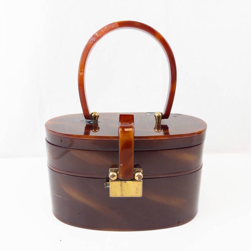 lot 164 image: Vintage tortoiseshell-look vanity boxpurse - oval case with top handle & brass hardware