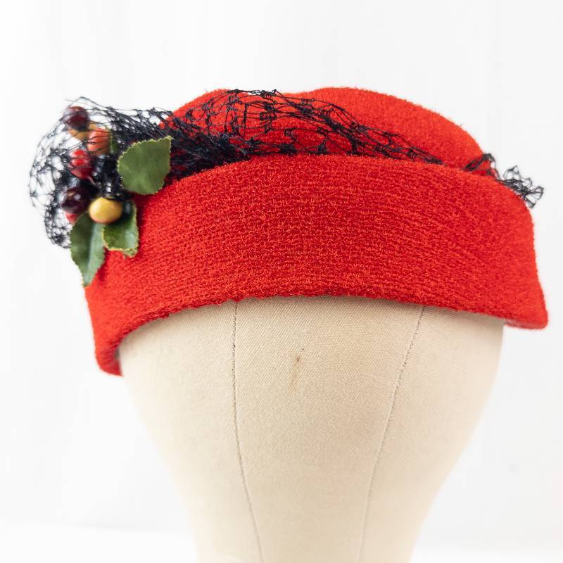lot 24 image: Red Pillbox Hat with Black Lace Netting and Berry Accent