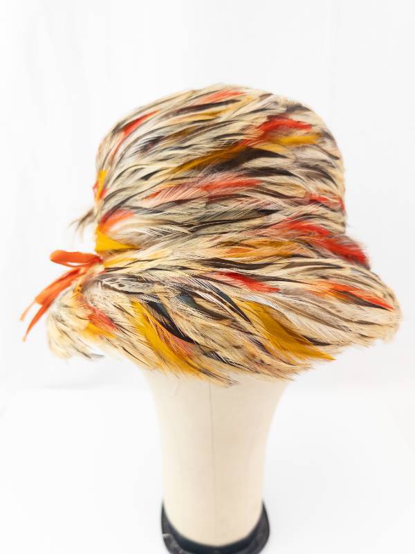 lot 42 image: My Hats From HAROLD- Feathered Cloche Hat - Multicolor Feathers with Orange Ribbon