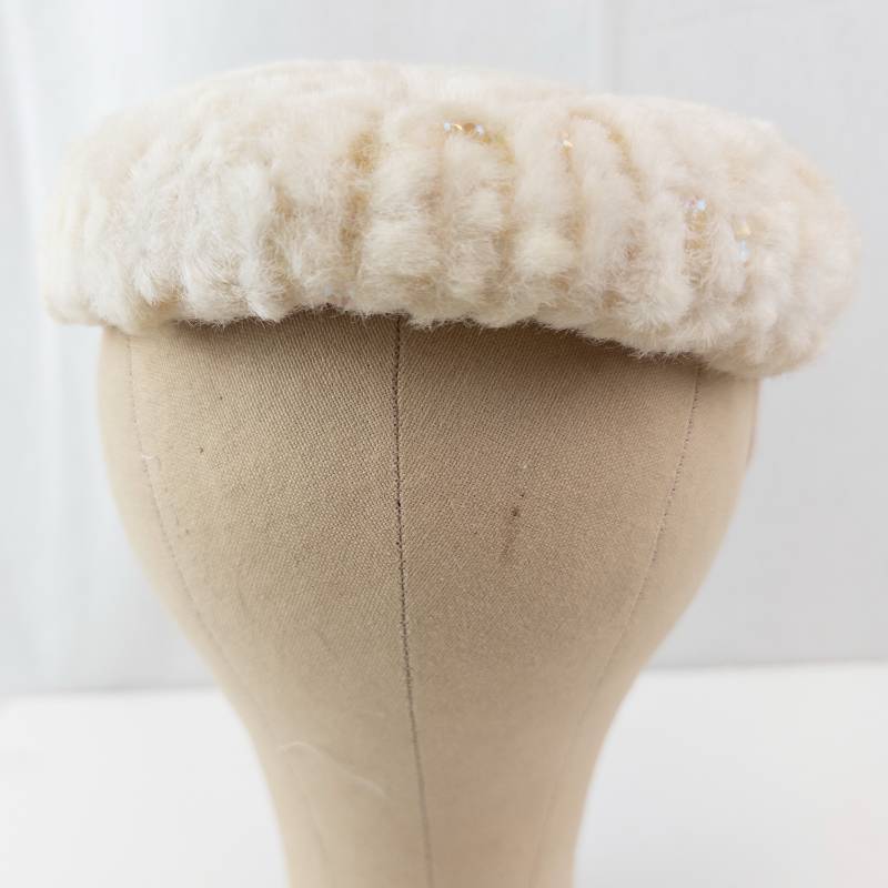 lot 55 image: Cream Faux Fur Hat with Beaded Petal Design
