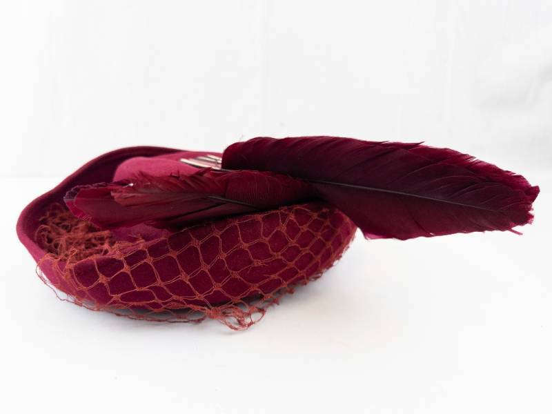 lot 63 image: Burgundy Velvet Pillbox Hat with Feather & Netting