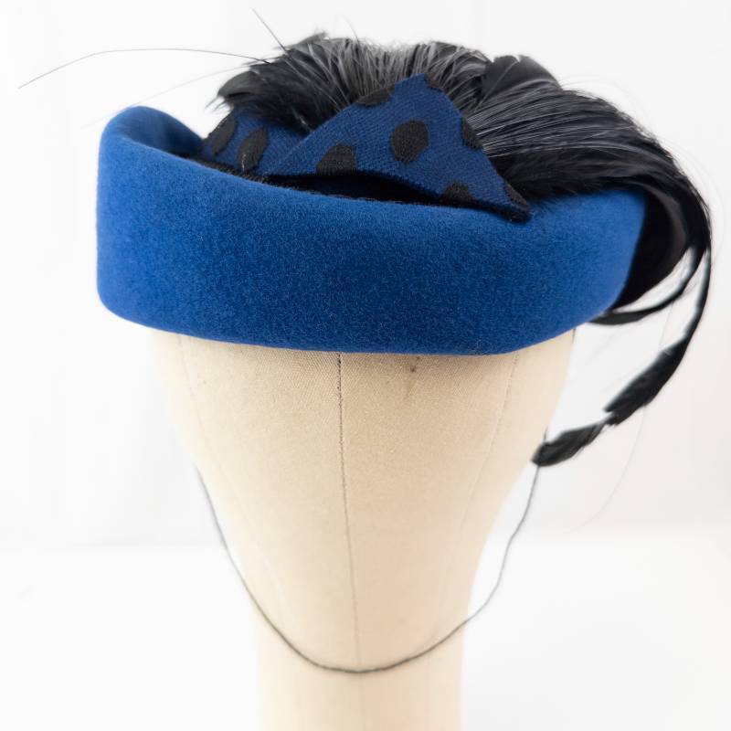lot 68 image: Sonni Lancasters Blue Felt Cloche Hat With Black Feather Accent