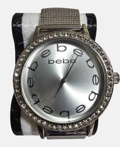 lot 27 image: Bebe Womens Silver Mesh Strap Watch with Rhinestone Bezel.