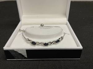 lot 23 image: RH MCYS & CO  Womens Sterling Silver Genuine Sapphire Stone Of Peace Adjustable Bracelet (Left Stone Is A Bit Cracked But Still Intact)