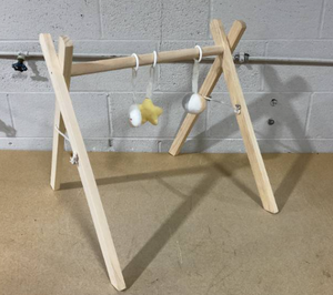 lot 242 image: Wooden Baby Play Gym - Natural Finish Pinewood Baby Activity Gym with 3 Sensory Hanging Toys - Safe and Durable for Infant Motor and Visual Development - Natural Wood (Missing Hardware)