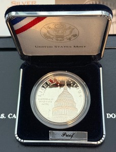 lot 99 image: 1994 S-US Capitol Proof Silver Dollar - original package with COA
