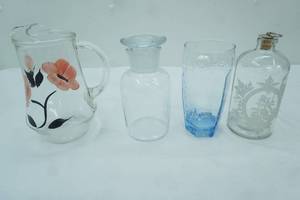 lot 49 image: water glass, vintage water pitcher with floral pattern, etched glass apothecary bottle with metal cork stopper