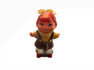 lot 33 image: Small Shots Vintage Doll on Roller Skate Board - Red Hair, Yellow Knit Sweater, Brown Pinafore Dress