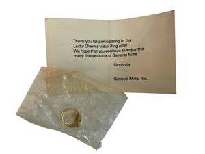 lot 106 image: Lucky Charms Initial Ring - Promotional Mailer from General Mills