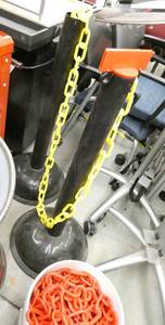 lot 37 image: 2 Chain stancions and a bucket of plastic chain