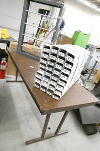 lot 251 image: Folding table with custom 32 slot organizer and a paper roll dispenser