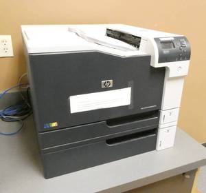 lot 311 image: HP Color laserjet printer model M750 with dual paper trays