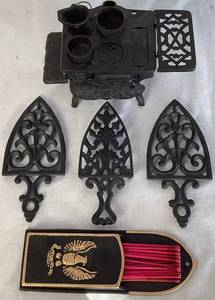 lot 129 image: Cast Iron Bundle - Cast Iron Matchstick Holder, Crescent Miniature Stove and Cast Iron Sad Iron Cathedral Trivets