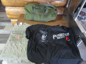 lot 132 image: Pendelton Whiskey Duffle Bag & T Shirts