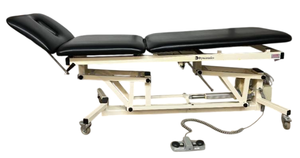 lot 88 image: MSRP $9500 Dynatronics Powered Treatment Table with Adjustable Height and Back Section, Foot Control Operation, Padded Upholstery and Mobile Base, Designed for Physical Therapy, Rehabilitation and Clinical Treatment Room Use  Works Great